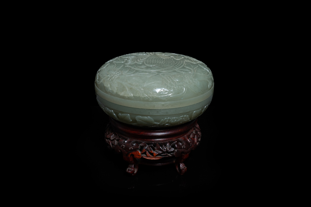 Een Chinese celadon jade dekseldoos met een feniks bij pioenbloesems, 19e eeuw